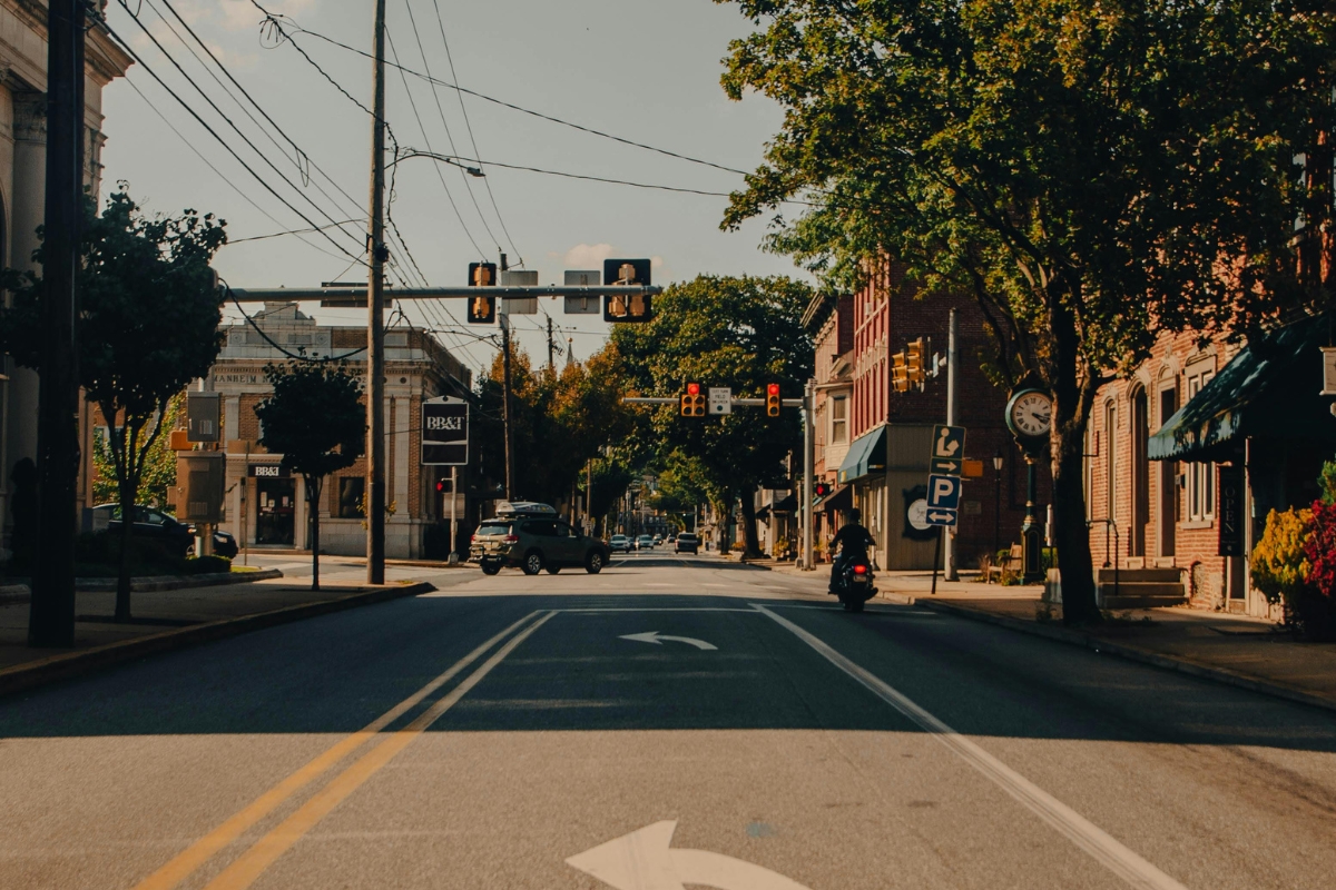 Downtown Broken Arrow, Oklahoma street view with small businesses, traffic lights, and a motorcycle on the road