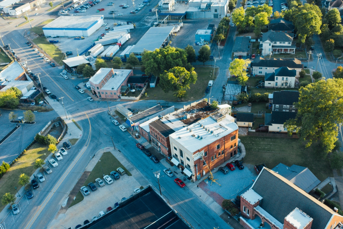 Aerial view of Jonesboro, Arkansas showing a mix of commercial buildings, residential homes, and streets with parked cars