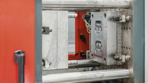 Injection mold tooling mounted in a plastic injection molding machine for precision manufacturing