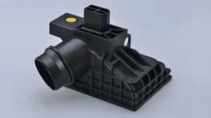 Injection-molded glass-filled nylon automotive housing with reinforced ribs and structural mounting features
